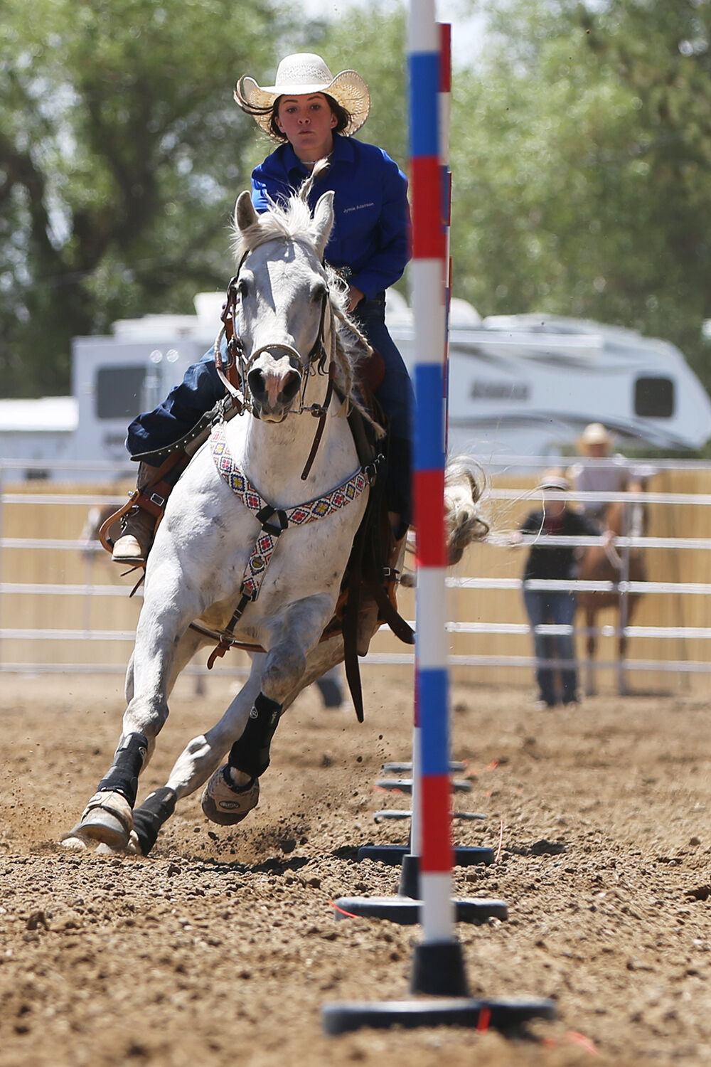 Jymie Adamson weaves between the poles during her pole bending run